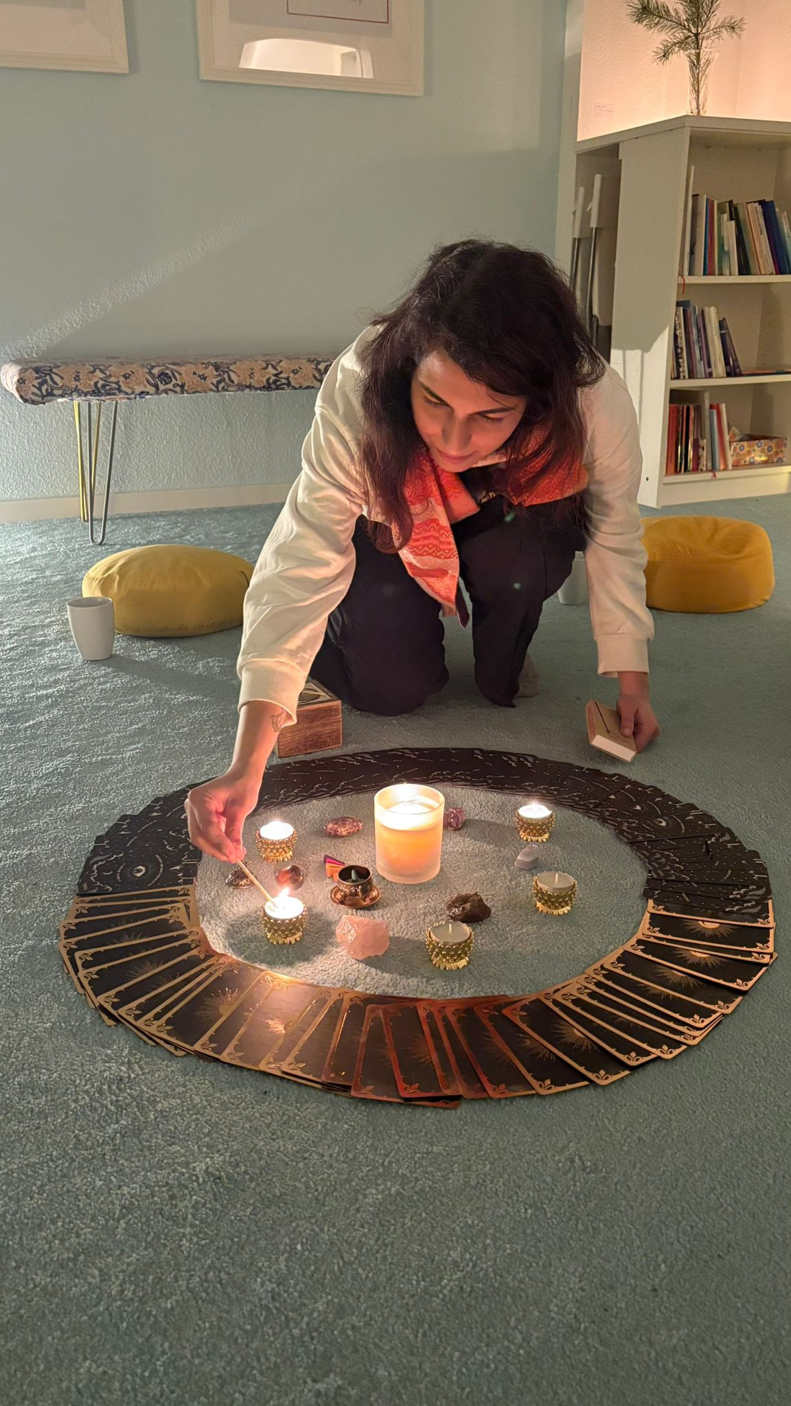 Ritika Arora setting up a ritual altar with tarot cards and candles